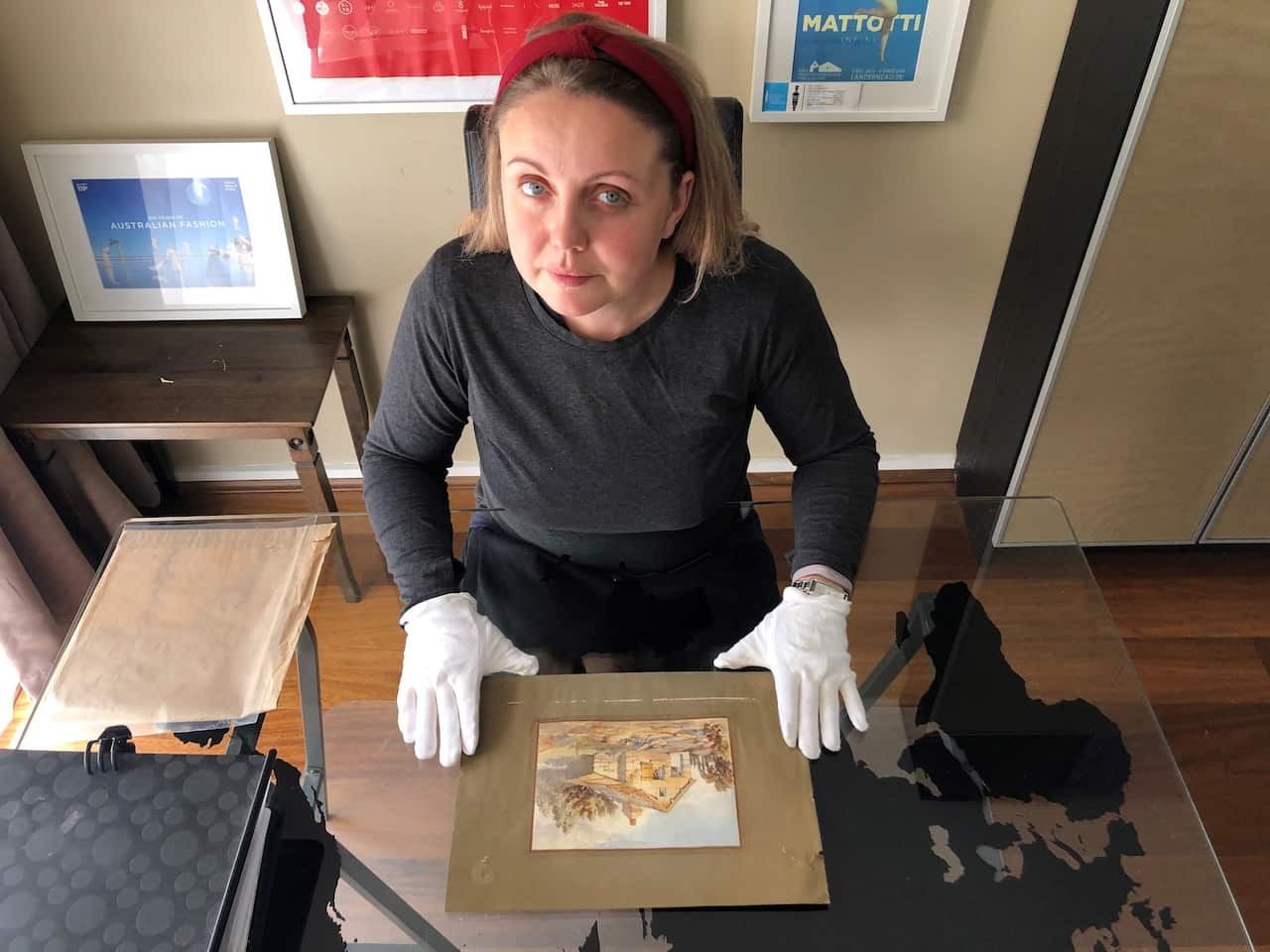 Anna Anisimova with a watercolor painting made by John James Clark