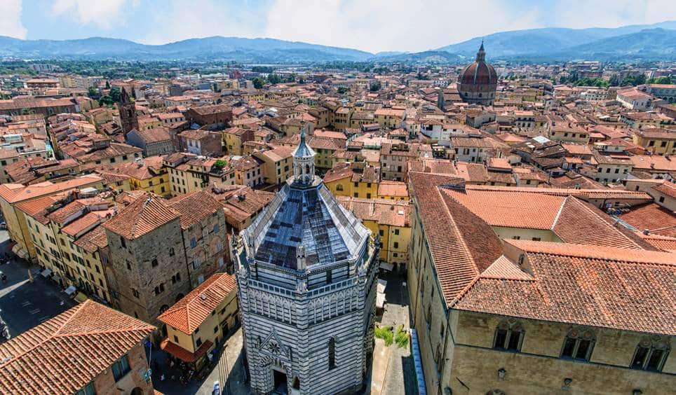 The octagonal 14th-century Baptistery amid the red pan-tiled roofs of Pistoia, Italy