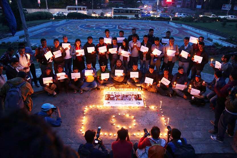Nepali journalists in attend a candle light vigil in Kathmandu in memory of the 10 journalists killed in Afghanistan.