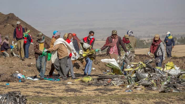 Rescue workers at Bishoftu Ethiopia, Monday, March 11, 2019, where Ethiopia Airlines Flight crashed on Sunday.