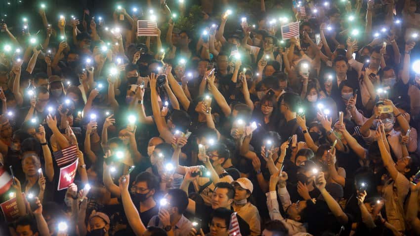 Protesters hold up the flashlights of their mobile phones at a rally at Chater Garden in the the Central district in Hong Kong, China, 14 October 2019.