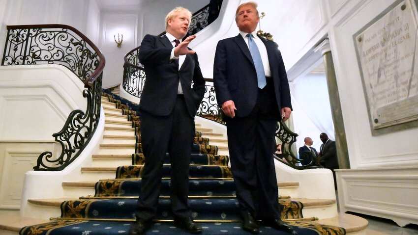 US President Donald J. Trump (R) and Britain's Prime Minister Boris Johnson (L) pose as they arrive for a bilateral meeting during the G7 summit in Biarritz