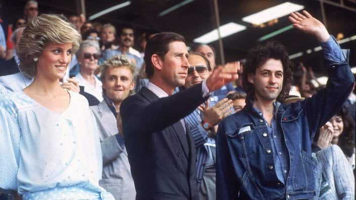 Princess Diana, left, and Prince Charles attend the Live Aid concert as they acknowledge the crowd with event organizer Bob Geldof, right
