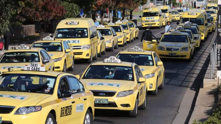 Taxi's line up at Melbourne Tullamarine airport  to collect passengers.