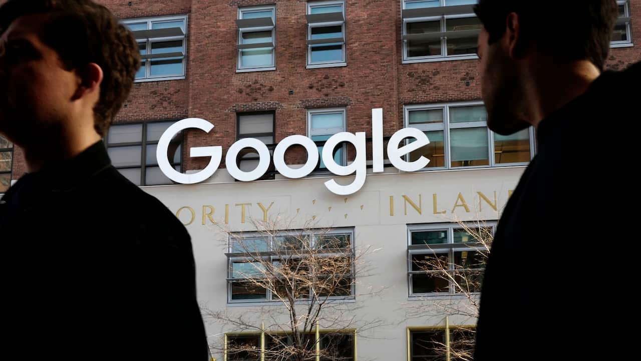 People walk by Google offices in New York