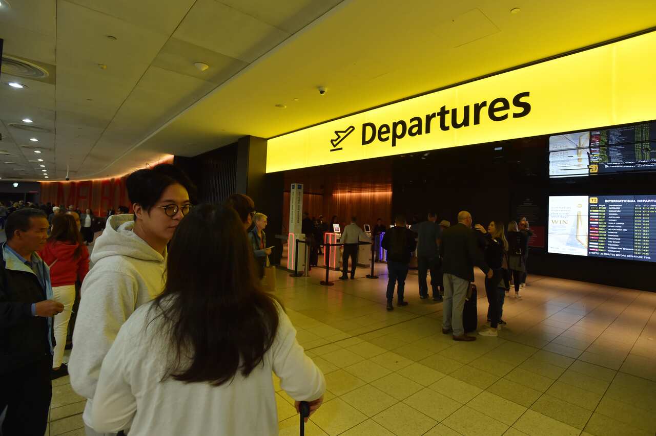 Watu wasubiri nje ya kiingilio cha wasafiri katika uwanja wa ndege wa Melbourne.