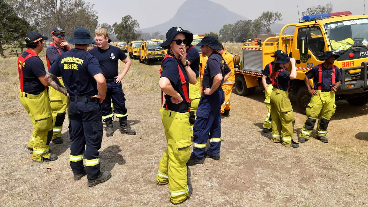 Rural firefighters are seen preparing to fight fires at Spicers Gap, south west of Brisbane, Wednesday, November 13, 2019. A number of homes have been destroyed by bushfires in New South Wales and Queensland. (AAP Image/Darren England) NO ARCHIVING