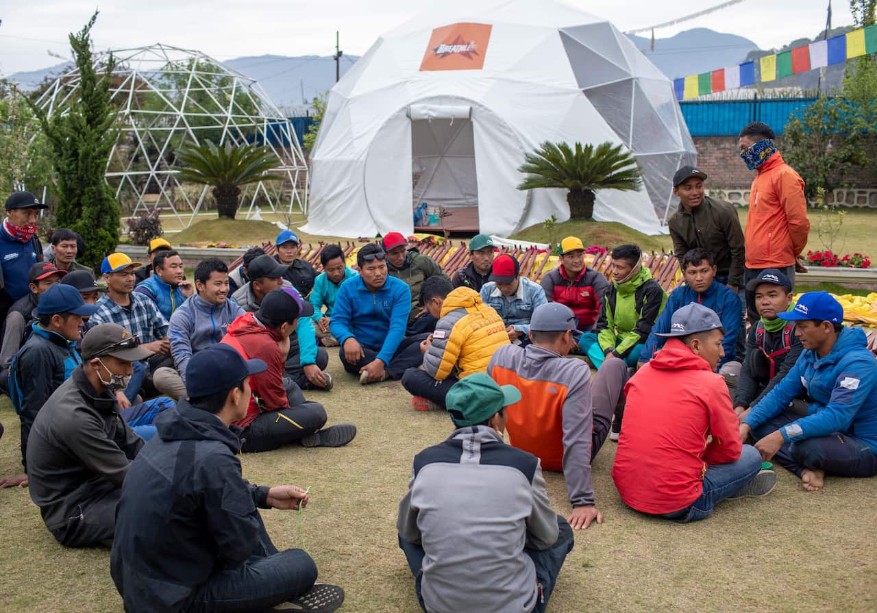 Nepalese Sherpas, who work as mountain guides, gather at the Seven Summit Trekking office