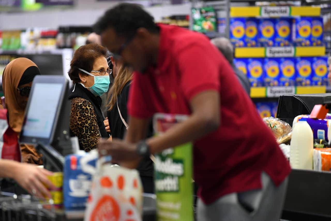 People shopping are seen in Woolworths supermarket in Coburg, Melbourne, Thursday, March 19, 2020.