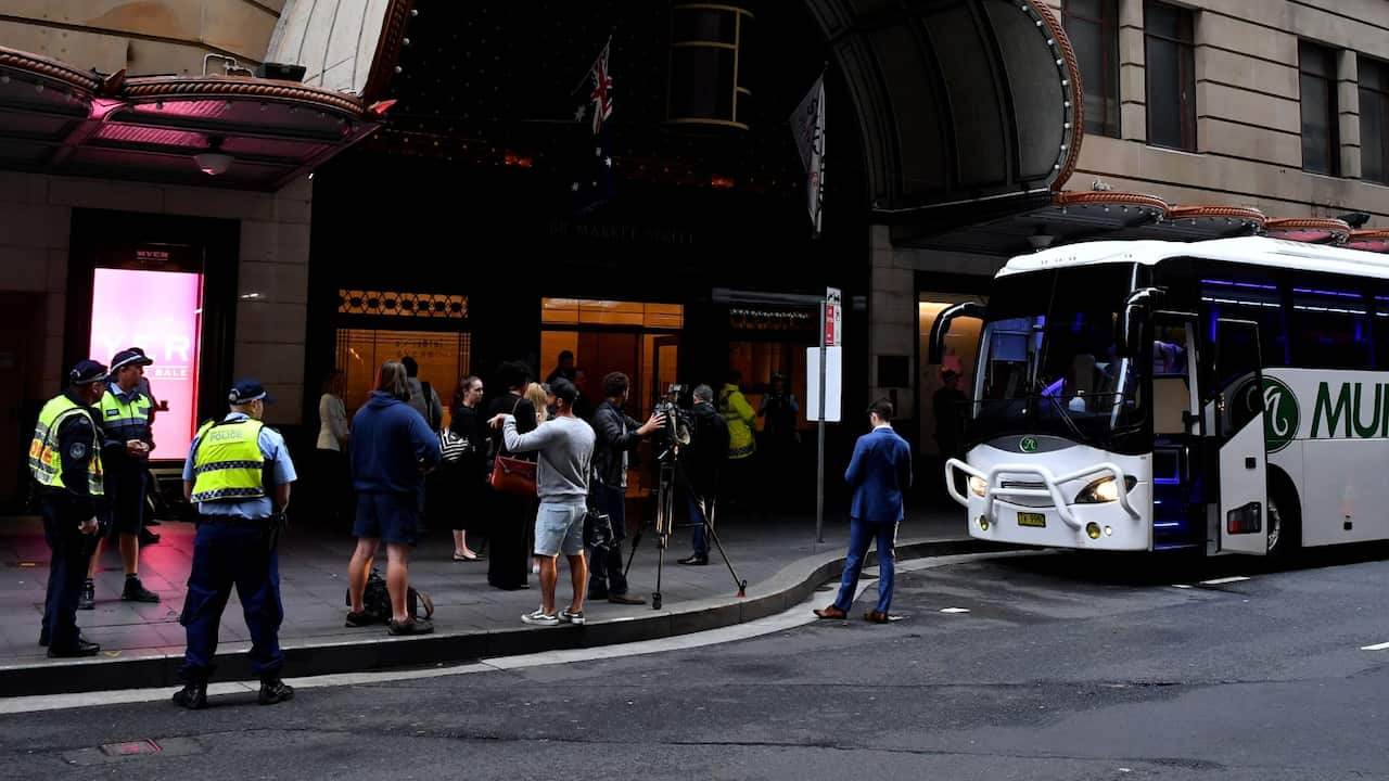 Police and media waiting in front of the isolation hotel in Sydney