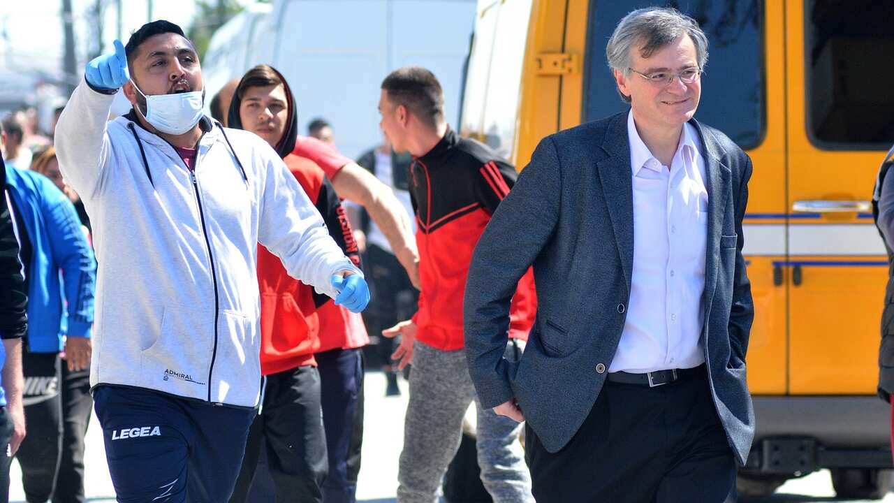Infectious diseases expert and health ministry spokesperson, Sotiris Tsiodras (R) arrives at a Roma settlement in Larissa city, Thessaly, Greece.