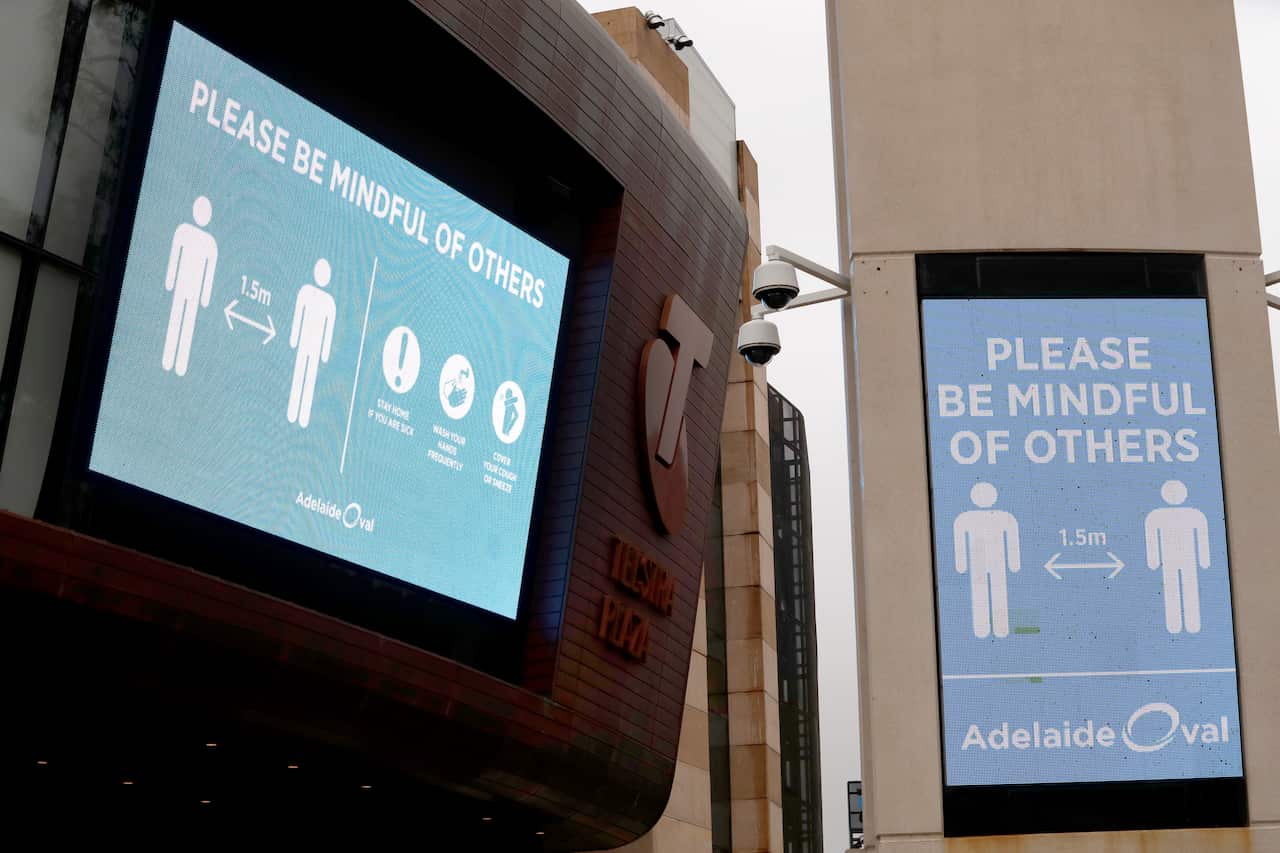 Social distancing signs are seen prior to the Round 2 AFL match between the Port Adelaide Power and the Adelaide Crows at Adelaide Oval in Adelaide, Saturday, June 13, 2020. (AAP Image/Kelly Barnes) NO ARCHIVING
