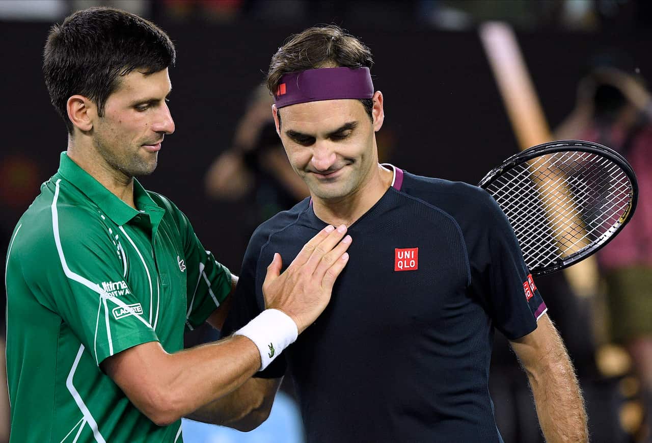 January 30, 2020, file photo, Switzerland's Roger Federer, right, congratulates Serbia's Novak Djokovic on winning their semifinal match at the Australian Open tennis championship in Melbourne, Australia. (AP Photo/Andy Brownbill, File)