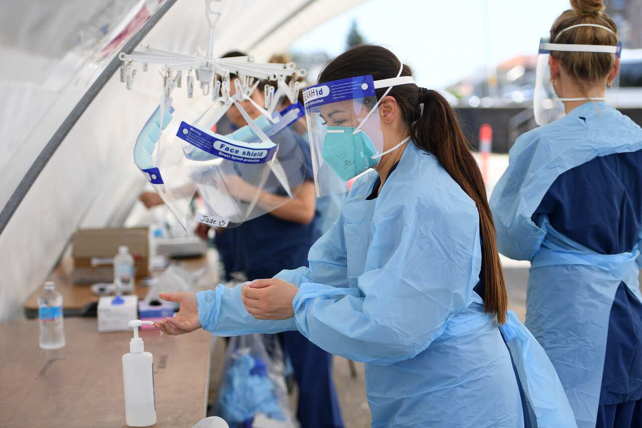 Nursing staff are seen at a coronavirus testing facility at Bondi Beach in Sydney, Thursday, October 15, 2020. COVID-19 clusters in Sydney continue to grow, with authorities issuing new alerts. (AAP Image/Dan Himbrechts) NO ARCHIVING