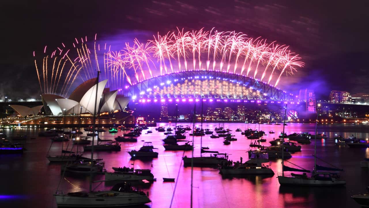 The midnight fireworks light up Sydney Harbour and the Sydney Harbour Bridge during New Year’s Eve celebrations