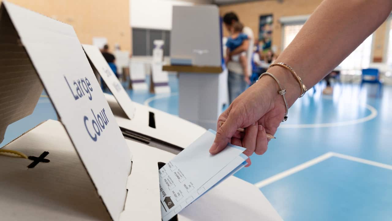 A member of the public casts their vote at a polling station in West Byford, Perth