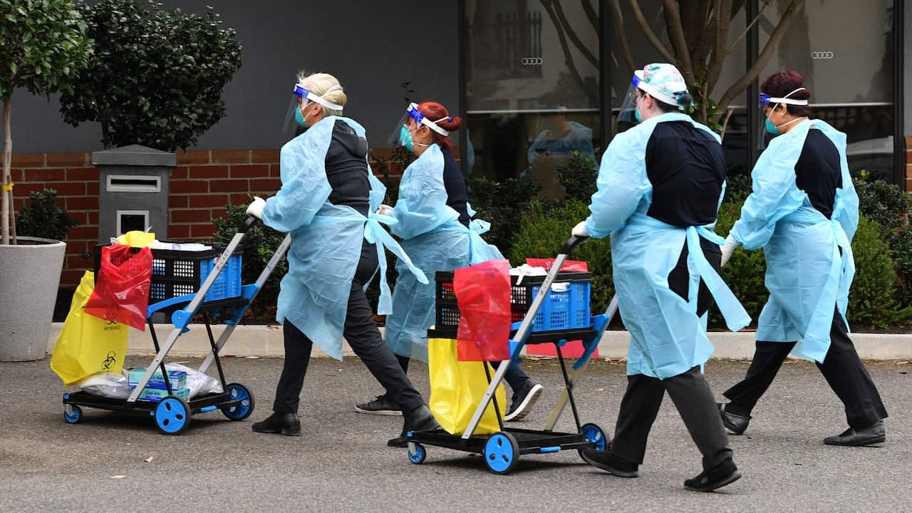 Healthcare workers are seen arriving to the Arcare Aged Care facility in Maidstone, Melbourne, Tuesday, June 1, 2021. Victoria has recorded three additional cases of coronavirus in the past 24 hours. 