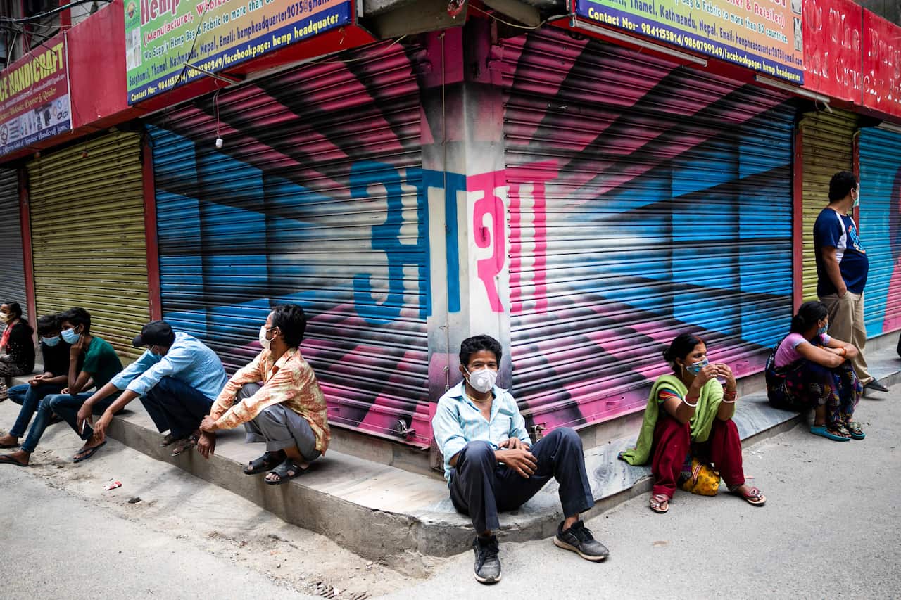 People wait for relief goods distributed by the community service center during the Prohibitory order due to a Second wave of the Coronavirus. (Photo by Prabin Ranabhat / SOPA Images/Sipa USA)