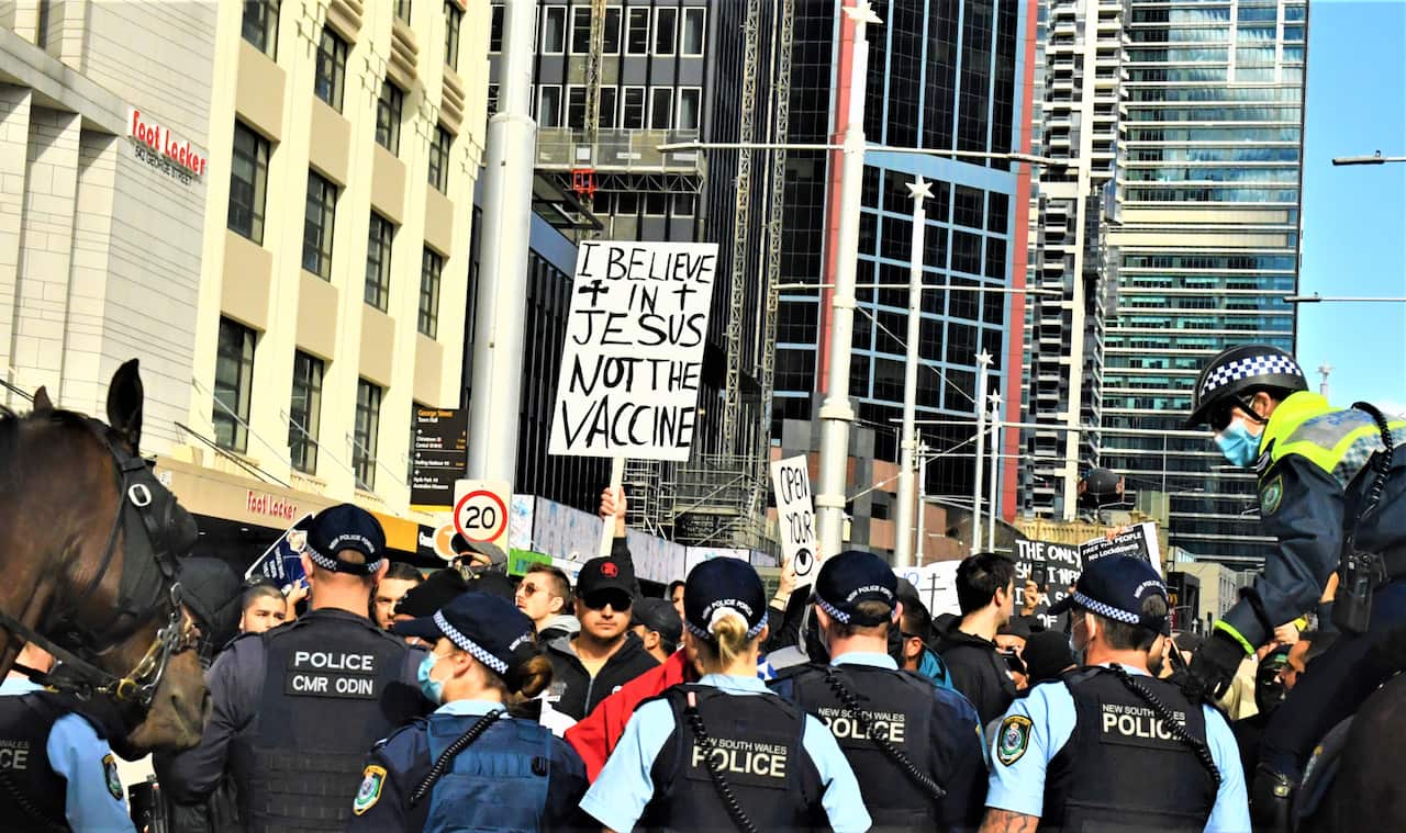 Protesters and police clash at Sydney Town Hall during the ‘World Wide Rally For Freedom’ anti-lockdown rally at Hyde Park in Sydney, Saturday, July 24, 2021. (AAP Image/Mick Tsikas) NO ARCHIVING