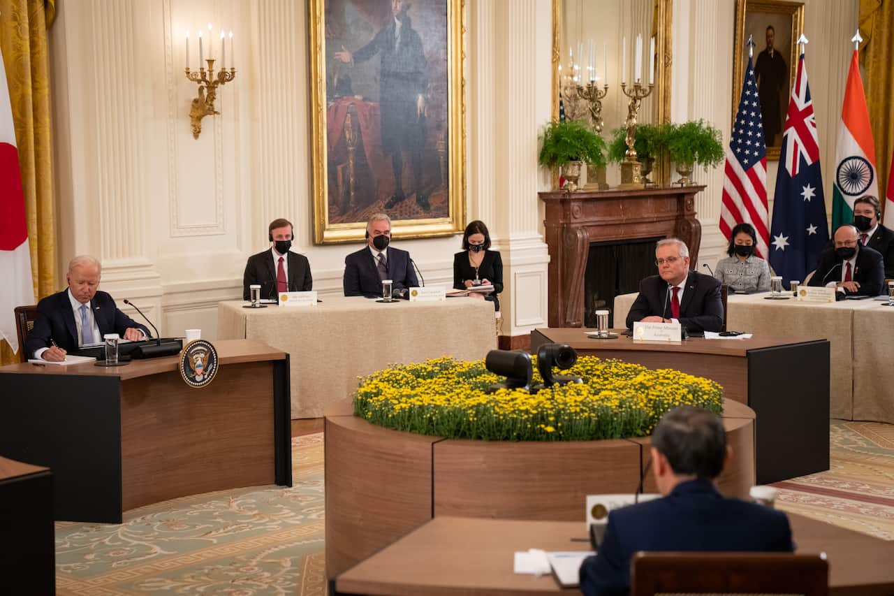 President Joe Biden, left, hosts a Quad Leaders Summit with Australian Prime Minister Scott Morrison, Japan Prime Minister Suga Yoshihide and India Prime Minister Narendra Modi (not pictured) in the East Room at the White House (AP)