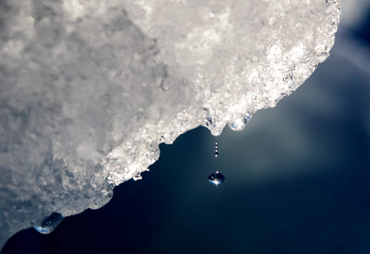 FILE - In this Aug. 1, 2017, file photo, a drop of water falls off an iceberg melting in the Nuup Kangerlua Fjord near Nuuk in southwestern Greenland.
