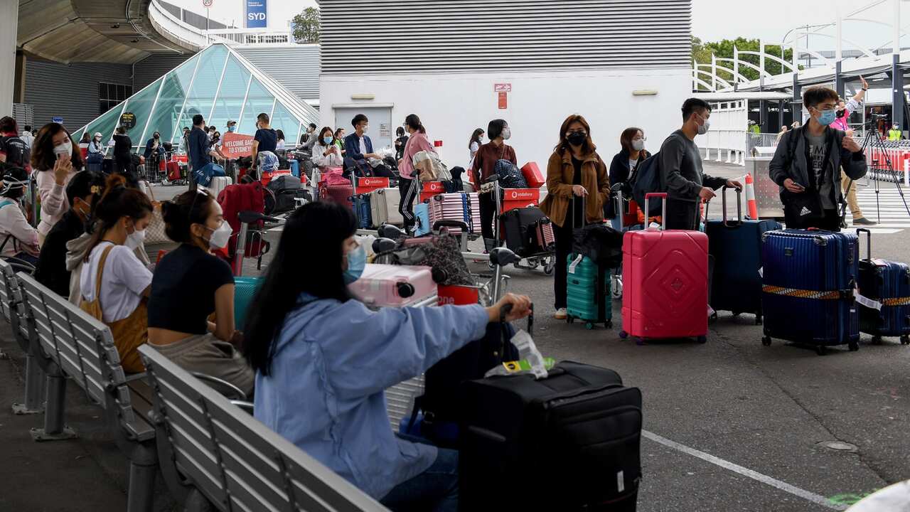 International students line up for coaches after arriving at Sydney Airport in Sydney.