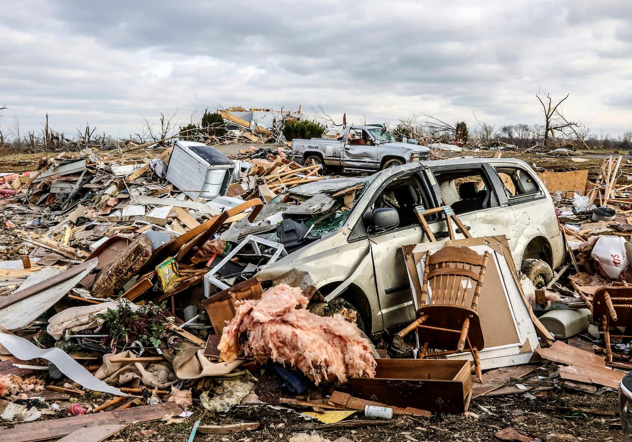 Damaged vehicles and personal property are strewn over a wide area along Kentucky 81, Saturday, Dec. 11, 2021, in Bremen, Ky, after a devastating tornado swept through the area on Friday night. (Greg Eans/The Messenger-Inquirer via AP)