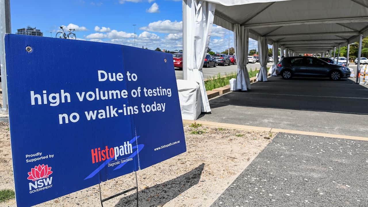 Members of the public queue in their cars for a COVID-19 PCR test at the Maroubra / Heffron Park Histopath Pathology Drive-through Clinic, in Sydney, Thursday, December 30, 2021. As COVID-19 case numbers soar and testing delays build up in NSW, Dominic Pe