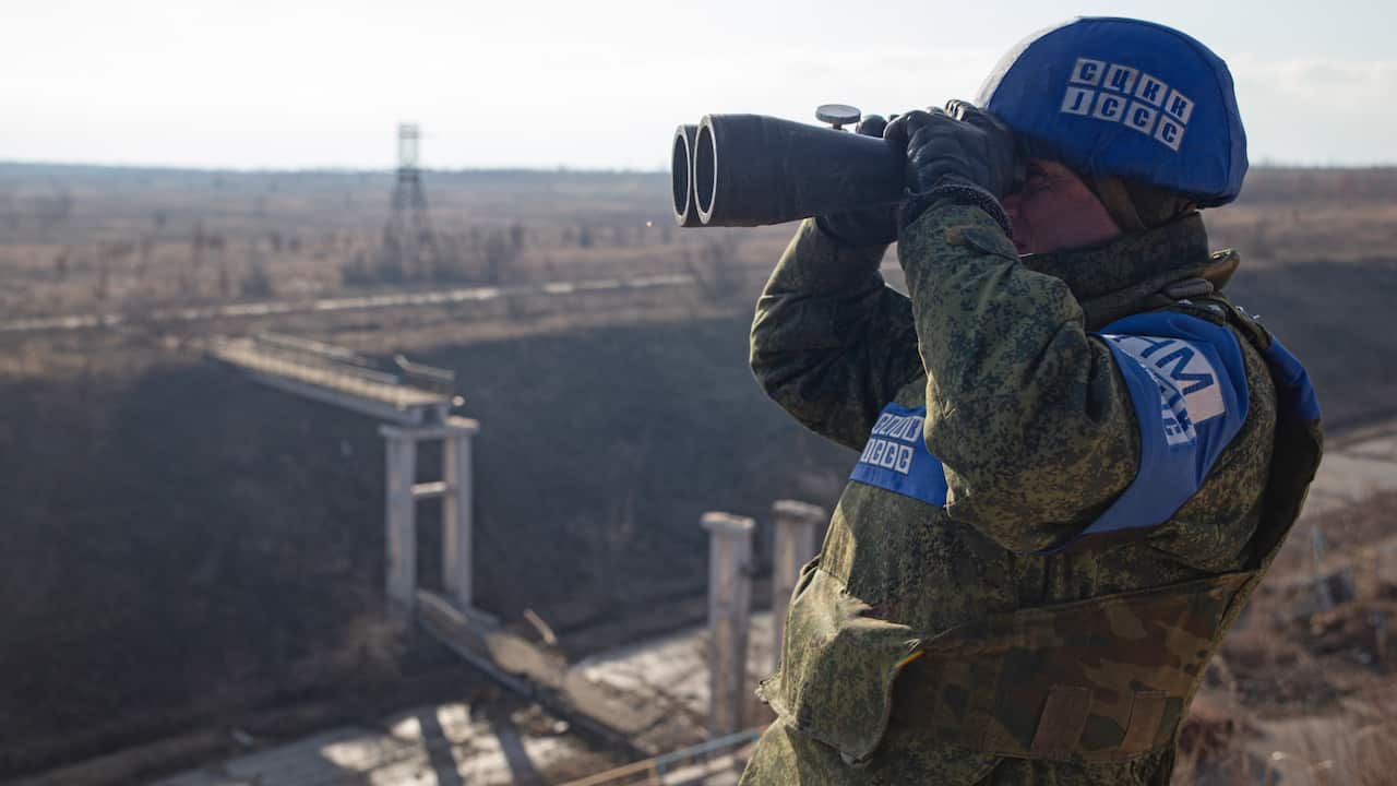 Representative of the Joint Centre for Control and Coordination (JCCC) on ceasefire and stabilization of the demarcation line looks through binoculars