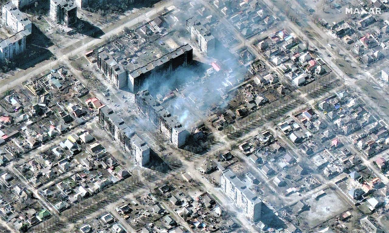 A handout satellite image made available by Maxar Technologies shows a burning high-rise apartment buildings in Mariupol, Ukraine, 22 March 2022.