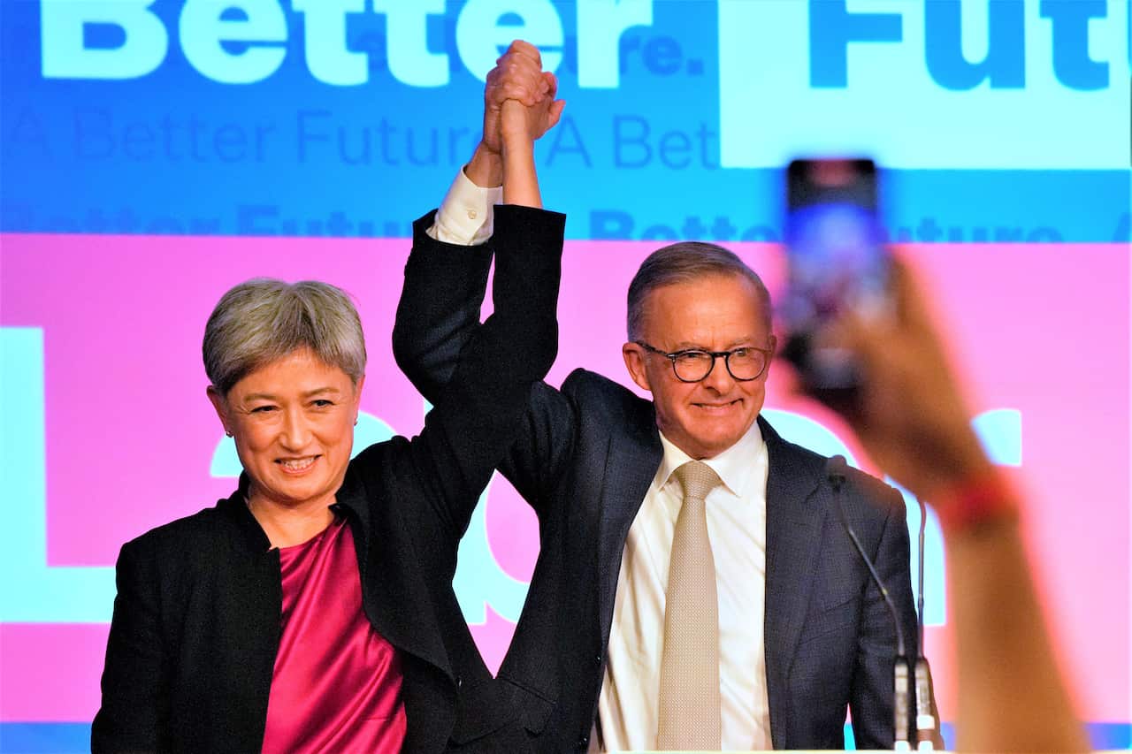 Labor Party leader Anthony Albanese, right, celebrates with Labor senator at a party event in Sydney, Australia, Sunday, May 22, 2022, after Prime Minister Scott Morrison conceding defeat to Albanese in a federal election. (AP Photo/Rick Rycroft)