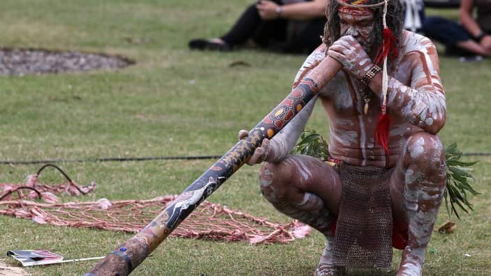 An Aboriginal man plays a didgeridoo during Australia Day in Sydney