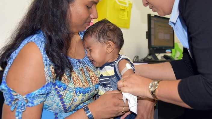 A child cries while getting the vaccine in the Northern Territory 