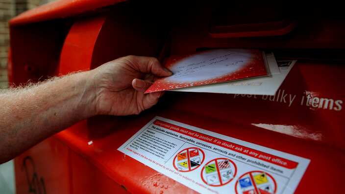 A man posts mail 