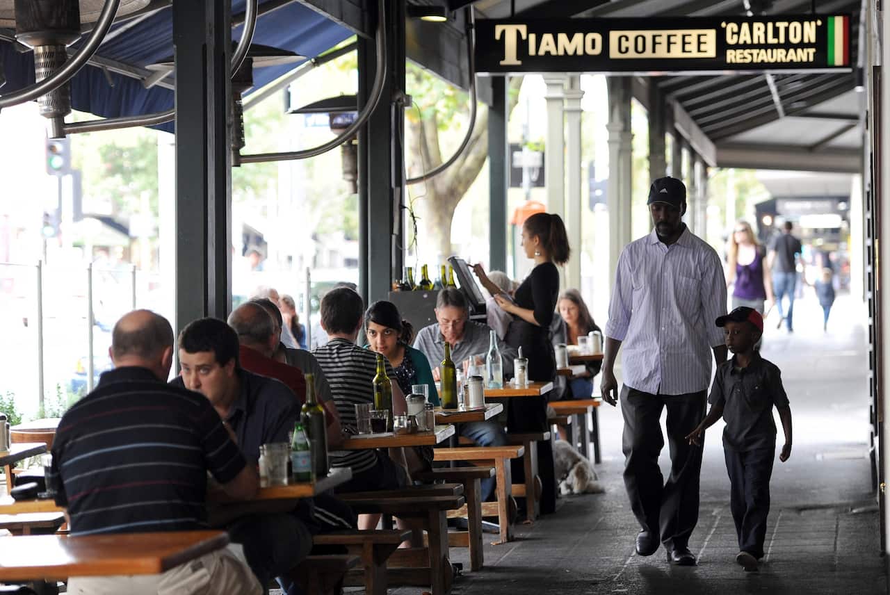 People sitting on the footpath outside cafe's in Lygon Street, Melbourne, Australia, on February 29, 2012, Australia.(AP Photo/Mal Fairclough)