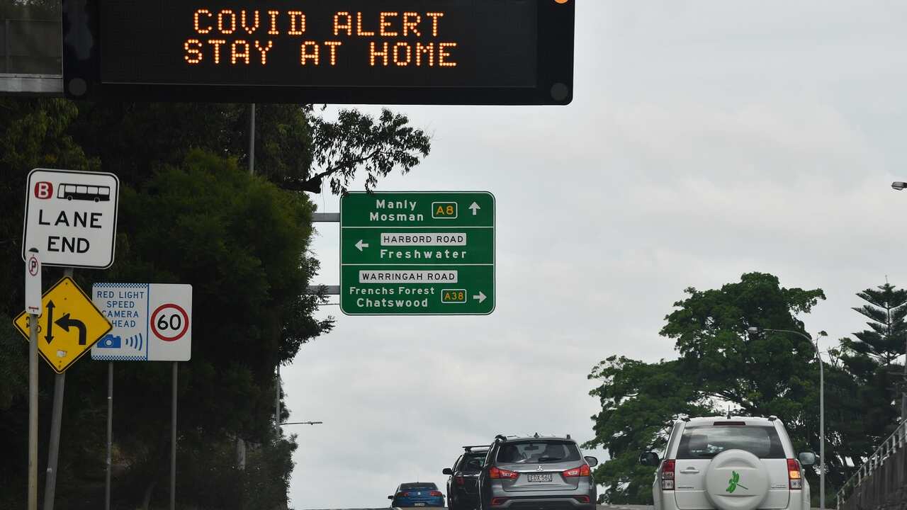 A sign on Pittwater Road instructs residents and visitors to stay home in the northern beaches of Sydney, Tuesday, December 22, 2020.