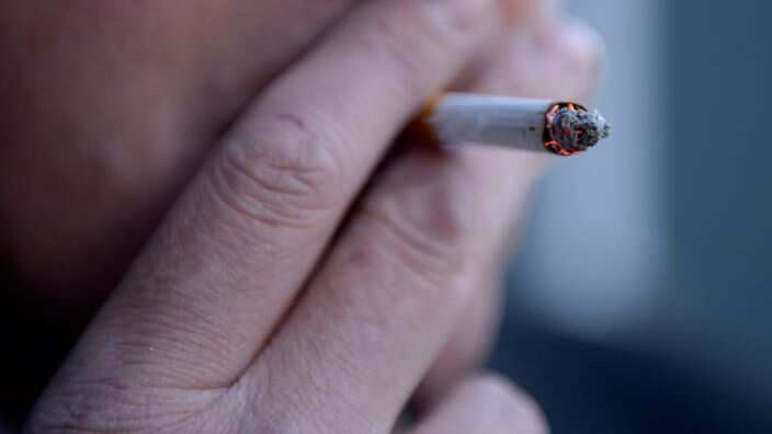 A smoker puffs on a cigarette