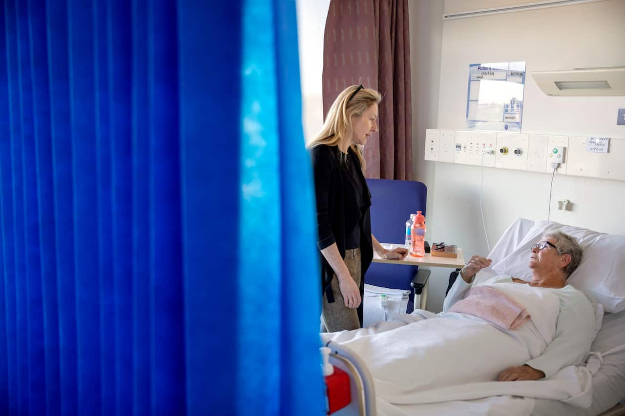 Dr. Jennifer Stevens, a pain specialist, talks with patient Cheryl Rowley who is awaiting surgery at St. Vincent's Hospital in Sydney, July 2019.