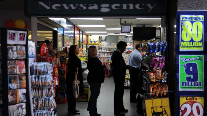 Sydney CBD workers line up at a newsagency to purchase their Powerbal entry, Sydney, Thursday, July 30, 2009. The Powerball jackpot of $80 million will be drawn tonight. (AAP Image/Dean Lewins) NO ARCHIVING