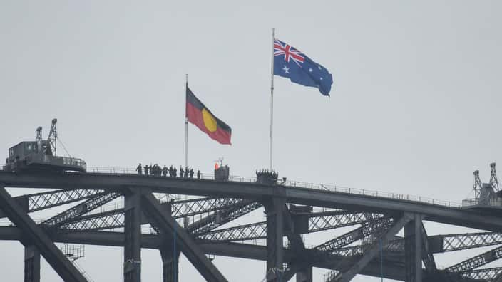 Australian and Aboriginal flags seen on the Harbour Bridge as part of Australia Day celebrations in Sydney, Monday, Jan. 26, 2015. (AAP Image/Joel Carrett) NN ARCHIVING