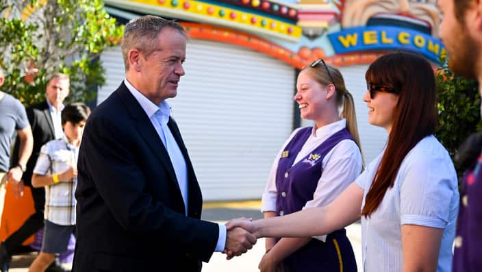 Australian Opposition Leader Bill Shorten greets workers during a visit to Luna Park in Melbourne, Saturday, April 20, 2019. (AAP Image/Lukas Coch) NO ARCHIVING