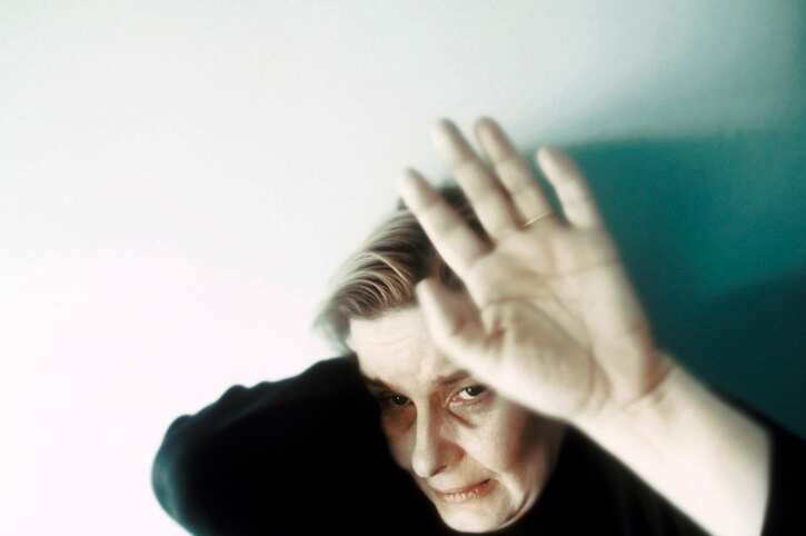 Battered woman raising her hand in self-defense