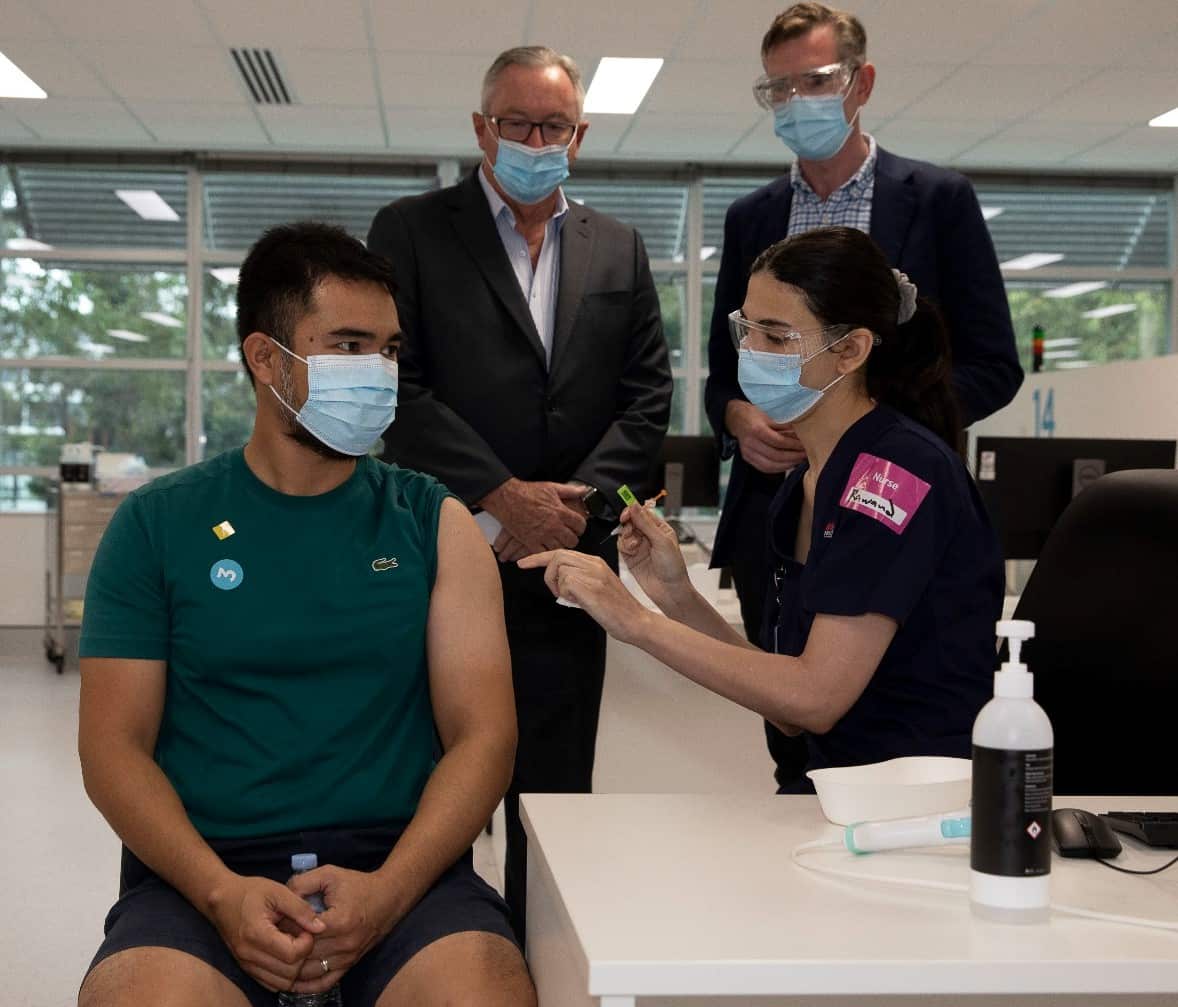 NSW Premier Dominic Perrottet and Brad Hazzard, Minister for Health and Medical Research NSW observe booster shots being administered during a visit to the Sydney Olympic Vaccination Hub.
