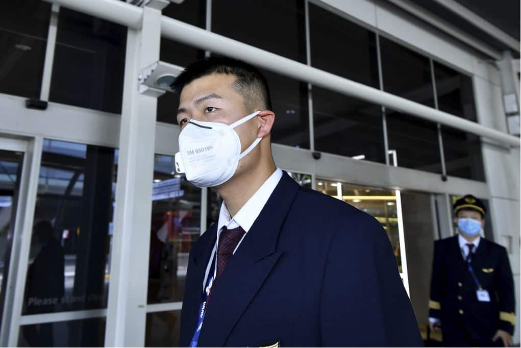 China Eastern Airlines flight crew wear protective masks on arrival at Sydney International Airport before the pandemic. 