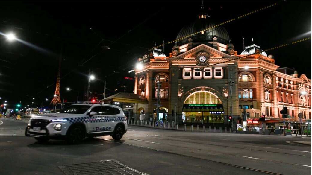 A police car is seen outside Flinders Street Station after a citywide curfew is introduced in Melbourne, Sunday, 2 August, 2020. 