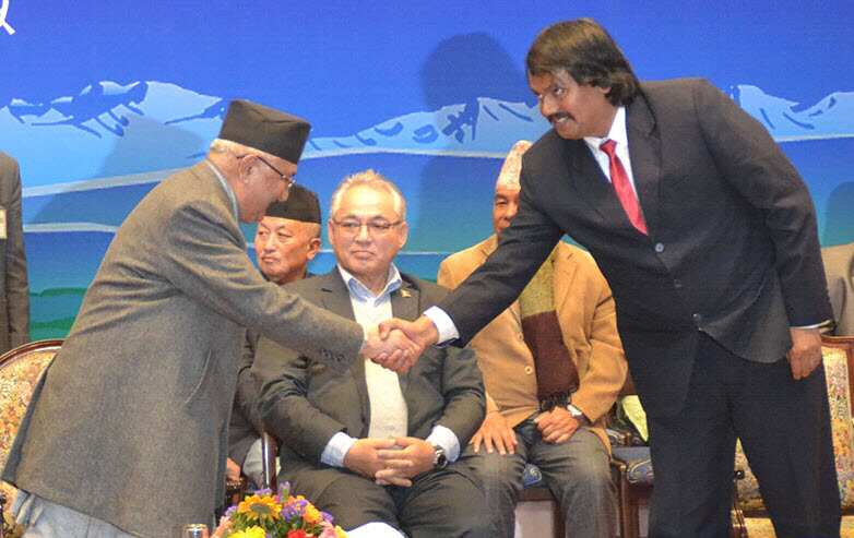 Nepal's Prime Minister KP Sharma Oli and Madhesh campaigner CK Raut shake hands after a 11 point agreement bringing Mr Raut to mainstream politics in Kathmandu.