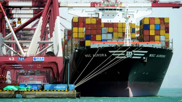 Containers being loaded on a cargo ship at the port in Qingdao in east China's Shandong province (AAP)
