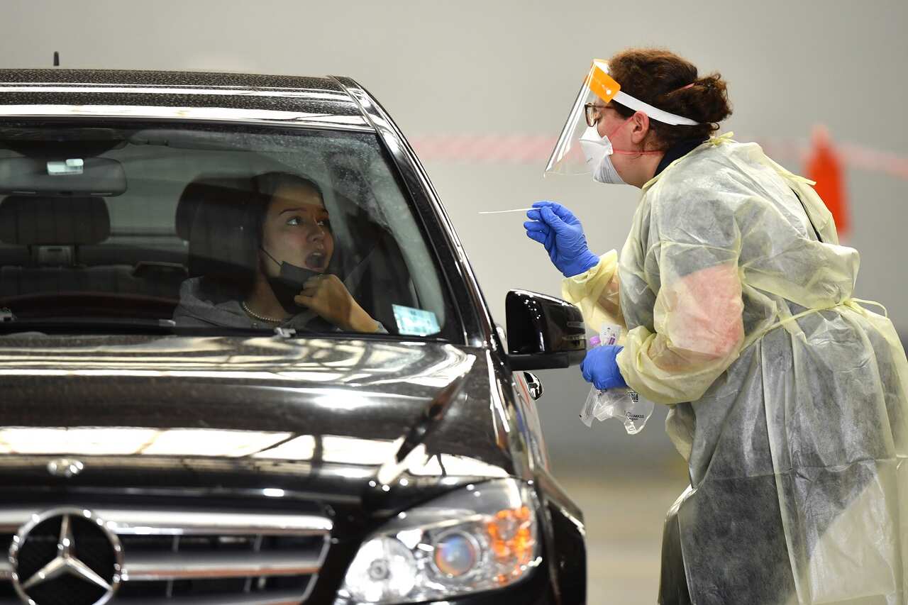 Members of the public are tested at a COVID-19 testing centre in Melbourne, Friday, March 18, 2022. No date is being given for the removal of the remaining few COVID-19 restrictions in Victoria as the state is warned to prepare for a challenging winter. (