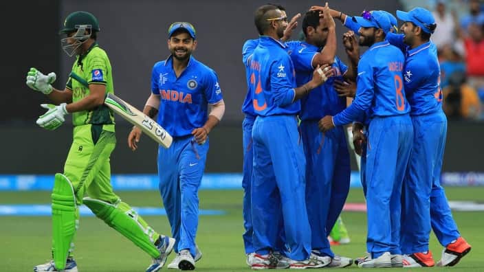 Pakistan's Younis Khan, left, walks back as Indian players celebrate his dismissal during the World Cup Pool B match in Adelaide, Australia, Sunday, Feb. 15, 2015. (AP Photo/James Elsby)