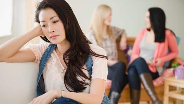 Sad woman isolated from friends